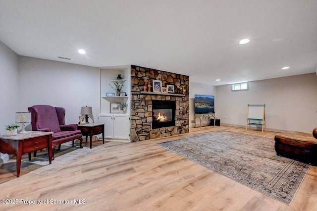 214 Oak St, Dunmore, PA 18512 - living room featuring wood finished floors, recessed lighting, a stone fireplace, and baseboards