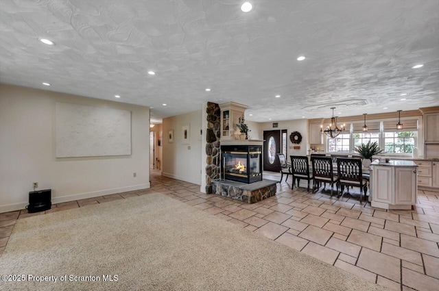 214 Oak St, Dunmore, PA 18512 - living area with a chandelier, recessed lighting, light tile patterned floors, a stone fireplace, and baseboards