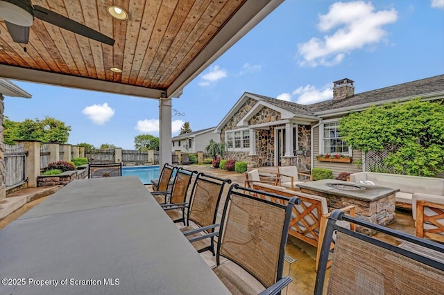 214 Oak St, Dunmore, PA 18512 - fenced backyard with a fire pit, a patio, a ceiling fan, and outdoor dining space