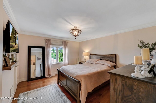214 Oak St, Dunmore, PA 18512 - bedroom with wood finished floors, ornamental molding, a chandelier, and baseboards