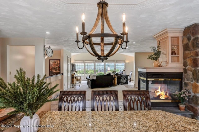 214 Oak St, Dunmore, PA 18512 - dining room featuring a chandelier and a multi sided fireplace