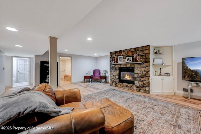 214 Oak St, Dunmore, PA 18512 - living area featuring wood finished floors, baseboards, recessed lighting, and a stone fireplace