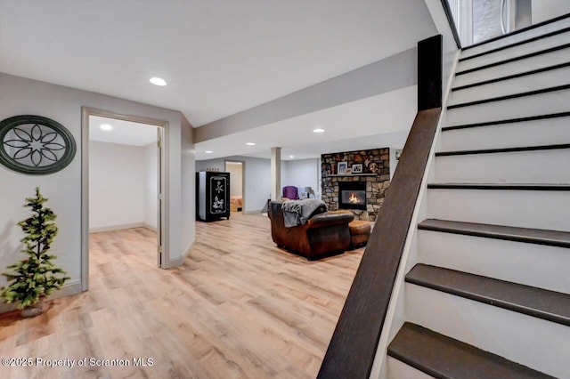 214 Oak St, Dunmore, PA 18512 - living area with stairway, light wood finished floors, a fireplace, baseboards, and recessed lighting