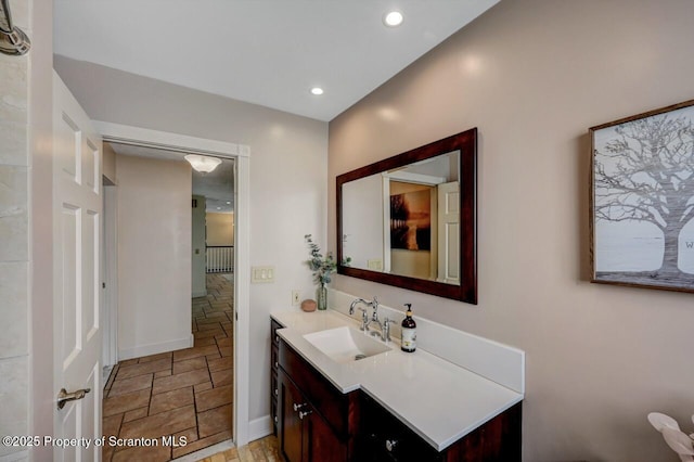 214 Oak St, Dunmore, PA 18512 - bathroom featuring stone tile flooring, vanity, recessed lighting, and baseboards