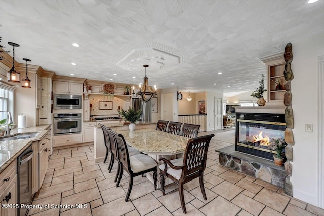 214 Oak St, Dunmore, PA 18512 - dining area featuring recessed lighting, a stone fireplace, and a chandelier