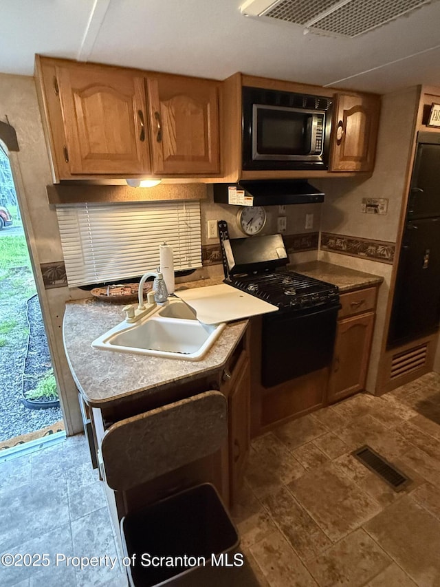 10 Lazy Squaw Trl, Gouldsboro, PA 18424 - kitchen with stainless steel microwave, black range with gas cooktop, and under cabinet range hood