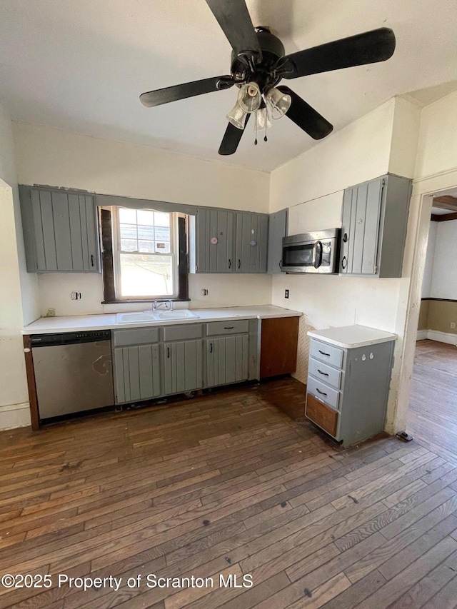 kitchen featuring light countertops, appliances with stainless steel finishes, and gray cabinetry