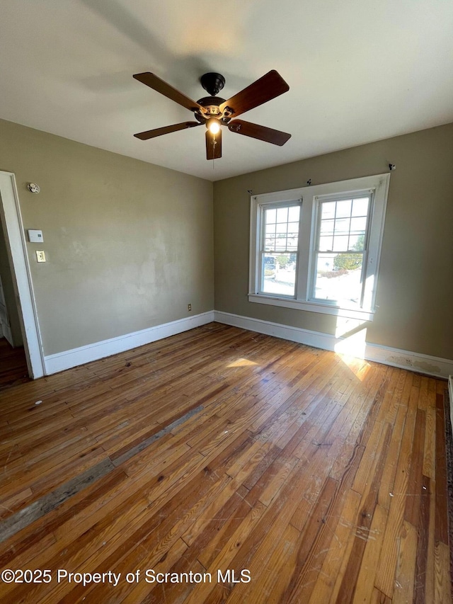 unfurnished room featuring baseboards and hardwood / wood-style floors