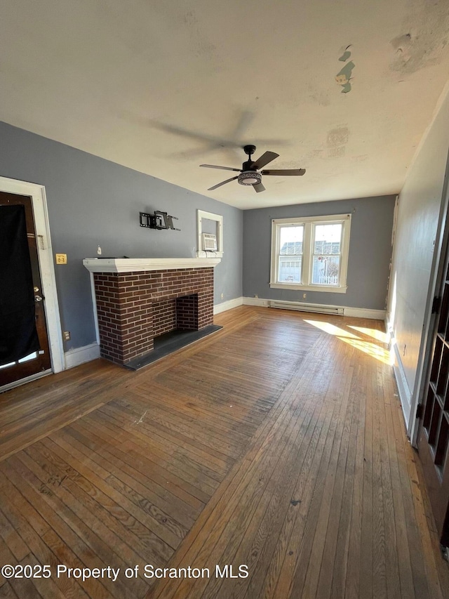 unfurnished living room featuring a baseboard heating unit, a brick fireplace, wood-type flooring, and baseboards