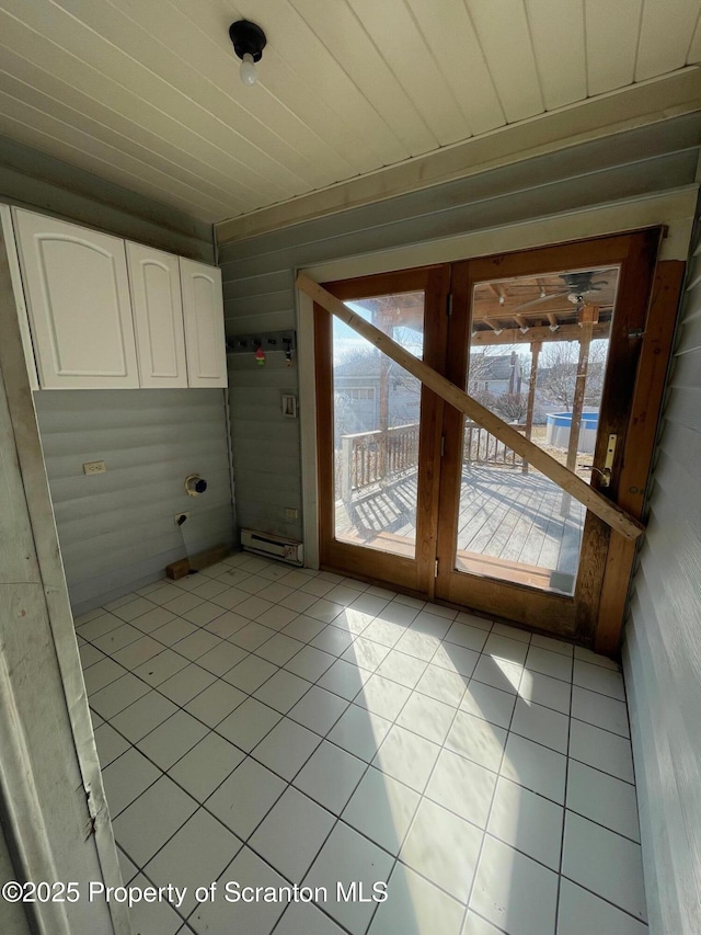 interior space featuring light tile patterned floors, a baseboard radiator, wood ceiling, and a healthy amount of sunlight