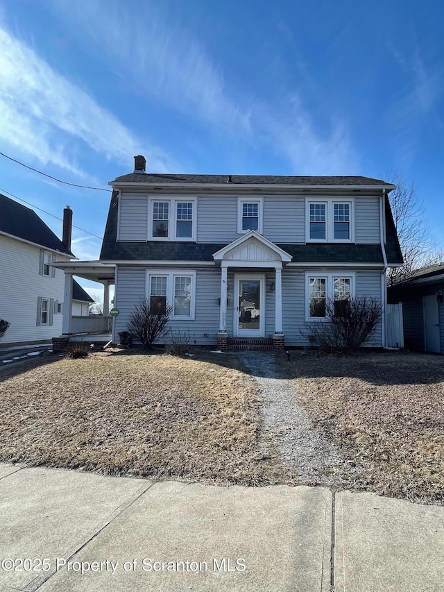 view of front of home featuring a chimney