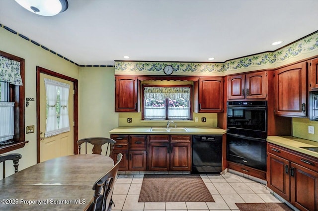 1614 Jefferson Ave, Dunmore, PA 18509 - kitchen featuring black appliances, a sink, light countertops, and light tile patterned floors