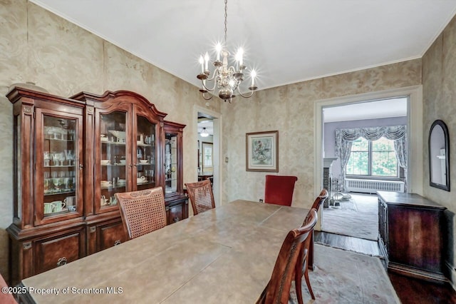 1614 Jefferson Ave, Dunmore, PA 18509 - dining area featuring a chandelier, wood finished floors, and radiator heating unit