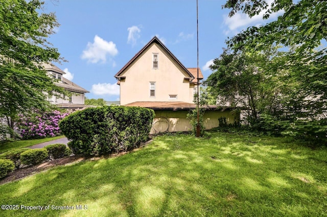 1614 Jefferson Ave, Dunmore, PA 18509 - view of home's exterior featuring stucco siding and a yard