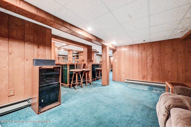 1614 Jefferson Ave, Dunmore, PA 18509 - living room featuring baseboard heating, carpet, wooden walls, a bar, and a drop ceiling
