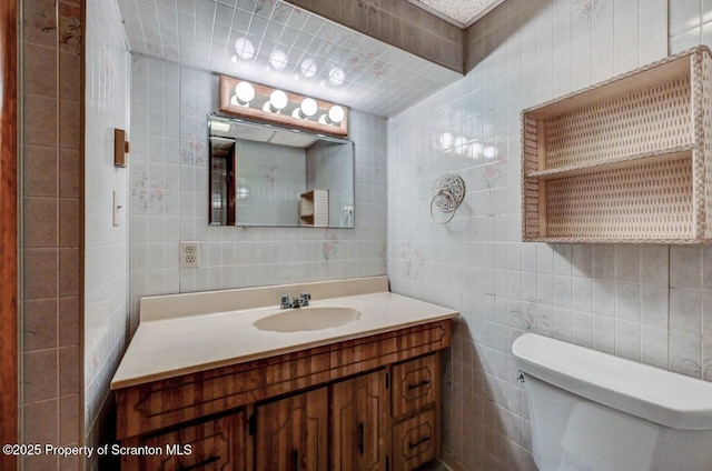 1614 Jefferson Ave, Dunmore, PA 18509 - half bathroom with tile walls, toilet, vanity, and decorative backsplash