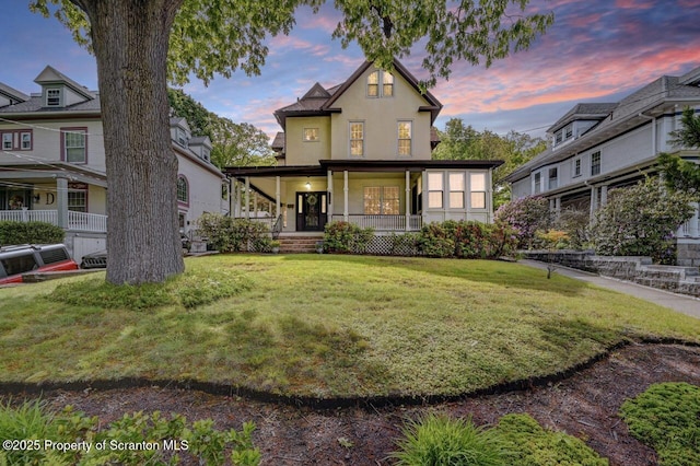 1614 Jefferson Ave, Dunmore, PA 18509 - view of front of property featuring covered porch, a yard, and stucco siding