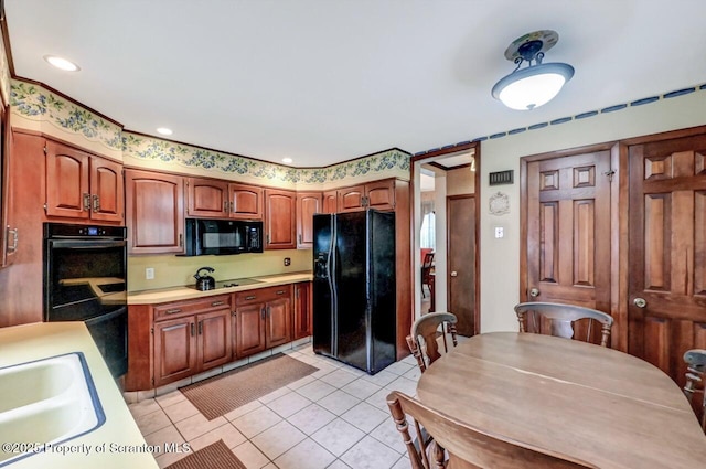 1614 Jefferson Ave, Dunmore, PA 18509 - kitchen with black appliances, light countertops, light tile patterned floors, a sink, and brown cabinetry