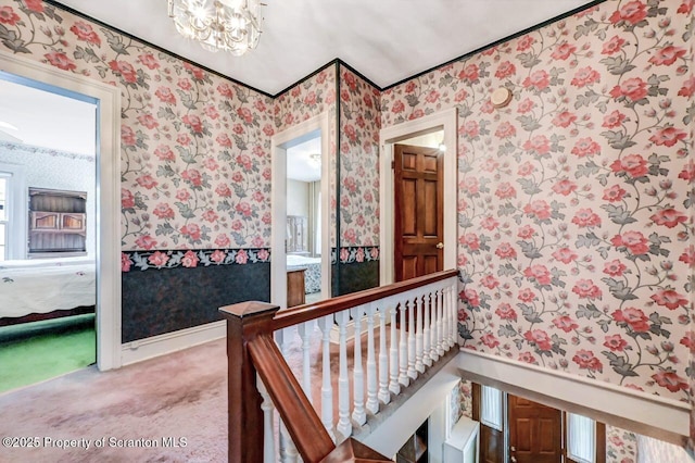 1614 Jefferson Ave, Dunmore, PA 18509 - corridor with wallpapered walls, a chandelier, wainscoting, and carpet flooring