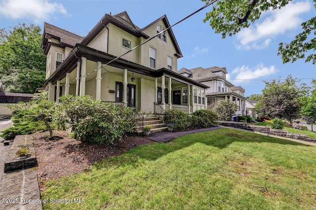 1614 Jefferson Ave, Dunmore, PA 18509 - view of side of home with covered porch, stucco siding, and a lawn