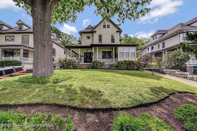 1614 Jefferson Ave, Dunmore, PA 18509 - view of front of home with covered porch, stucco siding, and a front yard