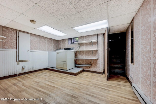 1614 Jefferson Ave, Dunmore, PA 18509 - basement featuring a baseboard radiator, washing machine and dryer, light wood-style floors, a drop ceiling, and wallpapered walls