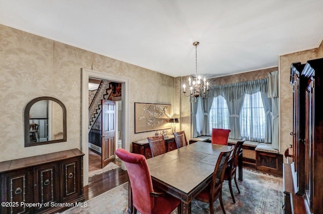 1614 Jefferson Ave, Dunmore, PA 18509 - dining space featuring a chandelier, dark wood-type flooring, stairs, and wallpapered walls
