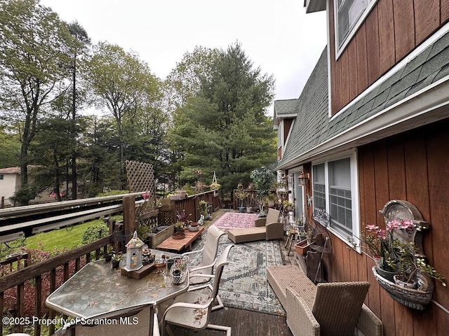 2119 Vacation Ln, Pocono Summit, PA 18346 - wooden terrace with outdoor dining space and view of wooded area