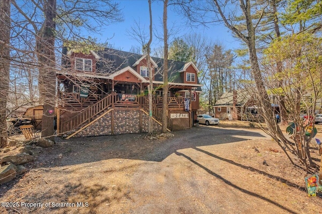 2119 Vacation Ln, Pocono Summit, PA 18346 - chalet / cabin with covered porch and stairs