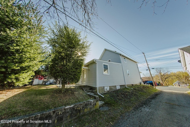 view of property exterior with a yard