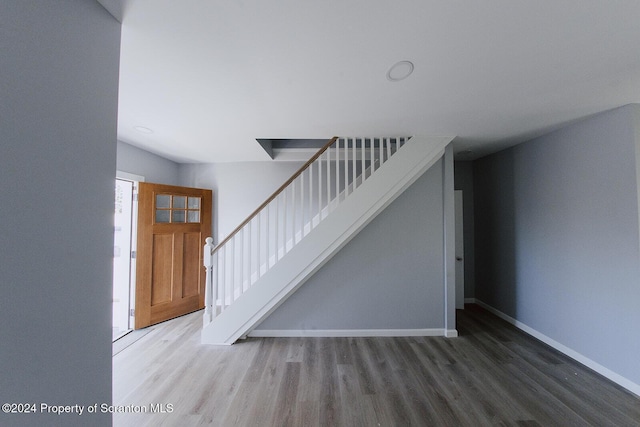 stairs featuring hardwood / wood-style flooring