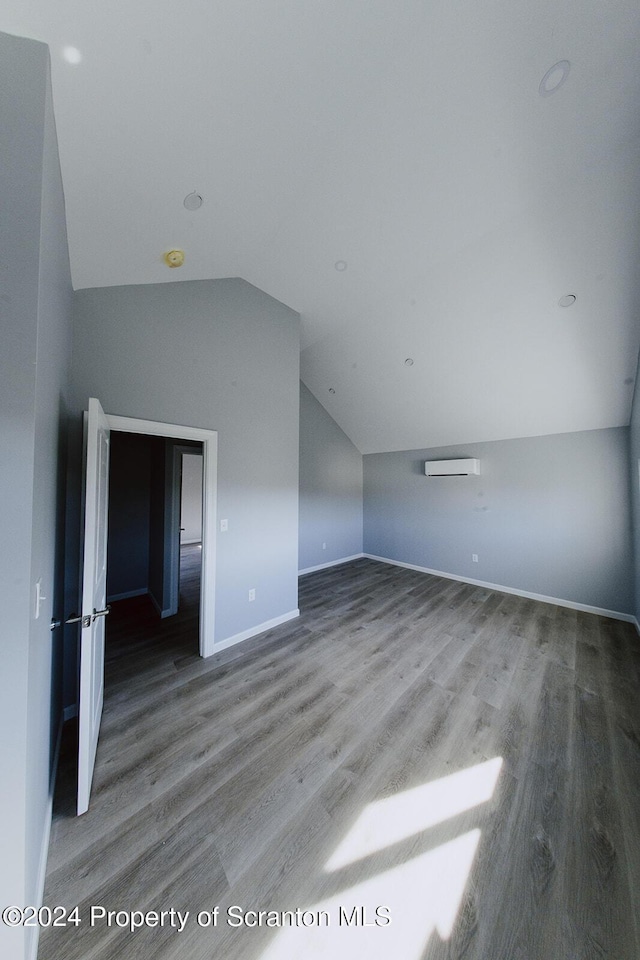 bonus room featuring vaulted ceiling and hardwood / wood-style flooring