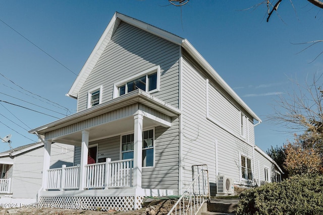 view of front of property with ac unit and a porch