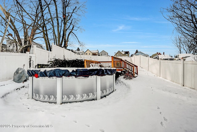 yard layered in snow featuring a covered pool