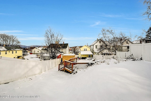 snowy yard featuring a deck