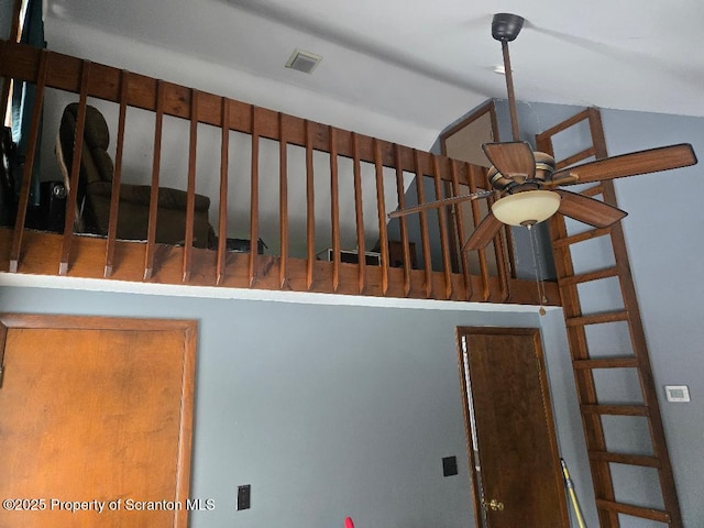 stairway featuring ceiling fan