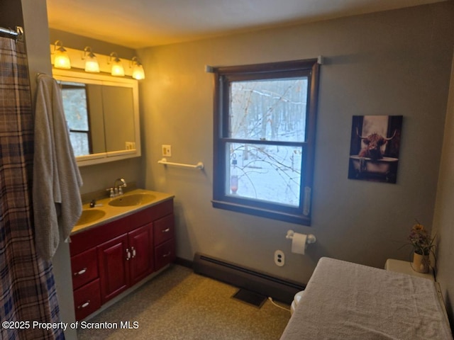 bathroom with vanity, a baseboard radiator, and plenty of natural light