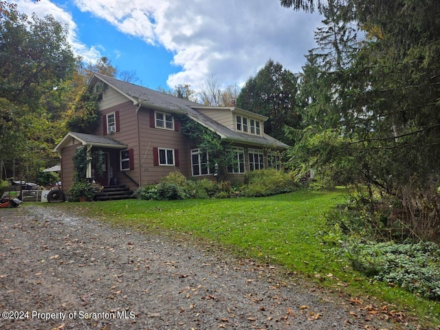 view of side of home featuring a lawn