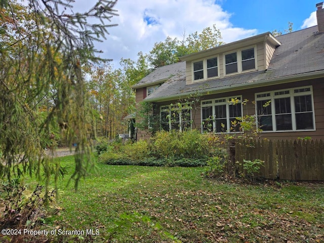 rear view of house with a yard