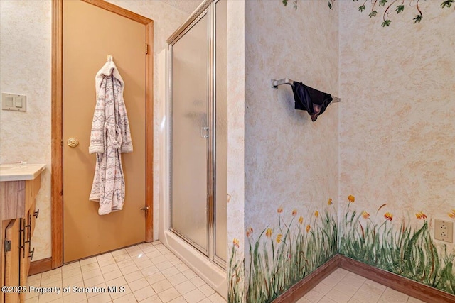 bathroom with vanity, a shower with door, and tile patterned floors