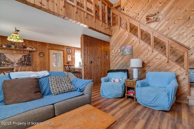 living room featuring wood-type flooring and wood walls