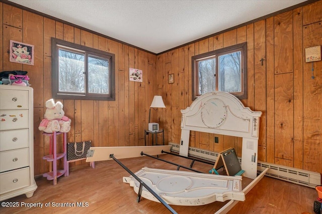 sitting room featuring wood-type flooring, a textured ceiling, and plenty of natural light