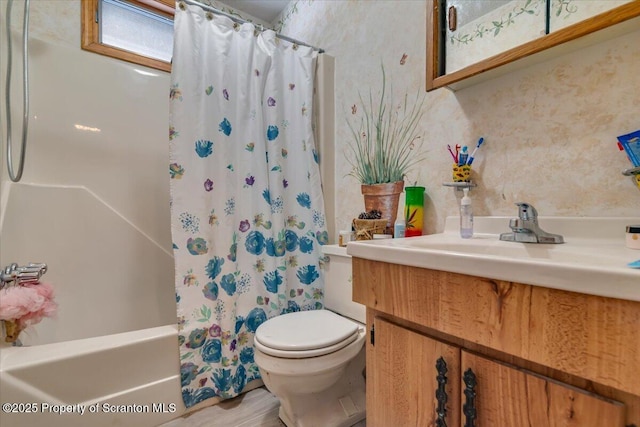 full bathroom featuring vanity, hardwood / wood-style floors, shower / tub combo with curtain, and toilet