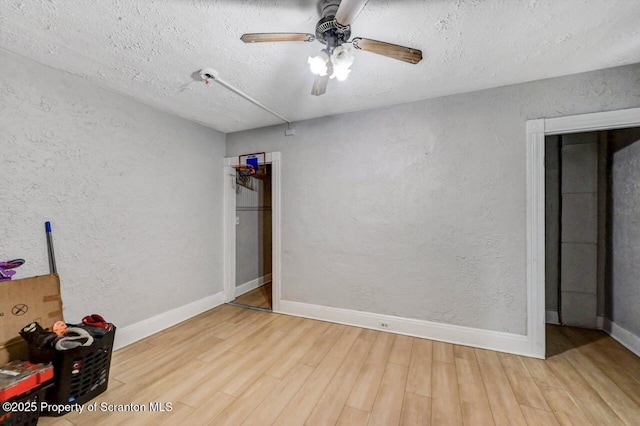 612 Farber Ct, Scranton, PA 18510 - unfurnished bedroom featuring wood finished floors, a textured ceiling, a textured wall, and ceiling fan