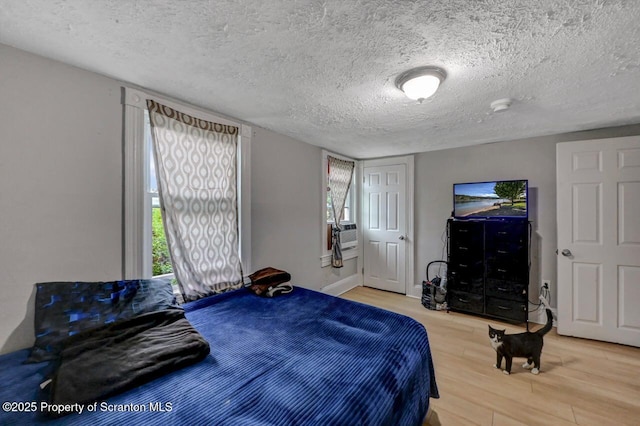 612 Farber Ct, Scranton, PA 18510 - bedroom with light wood-type flooring, a textured ceiling, and cooling unit