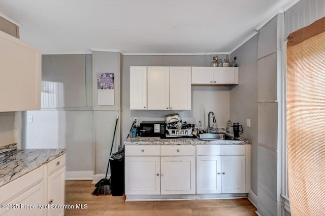 612 Farber Ct, Scranton, PA 18510 - kitchen with white cabinetry, light wood-style floors, crown molding, and light stone counters