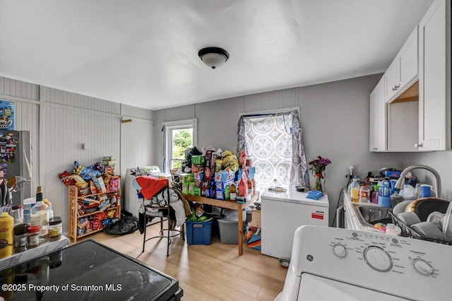 612 Farber Ct, Scranton, PA 18510 - kitchen featuring washer / dryer, light wood-type flooring, white cabinetry, light countertops, and freestanding refrigerator
