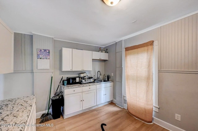 612 Farber Ct, Scranton, PA 18510 - kitchen featuring white cabinetry, light wood-style flooring, crown molding, and light stone counters
