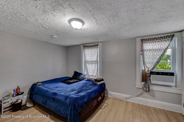 612 Farber Ct, Scranton, PA 18510 - bedroom with wood finished floors, a textured ceiling, and cooling unit