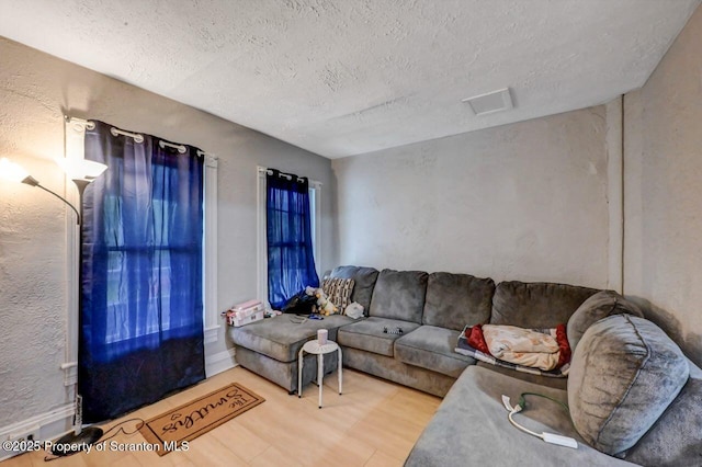 612 Farber Ct, Scranton, PA 18510 - living room featuring a textured ceiling, wood finished floors, and a textured wall